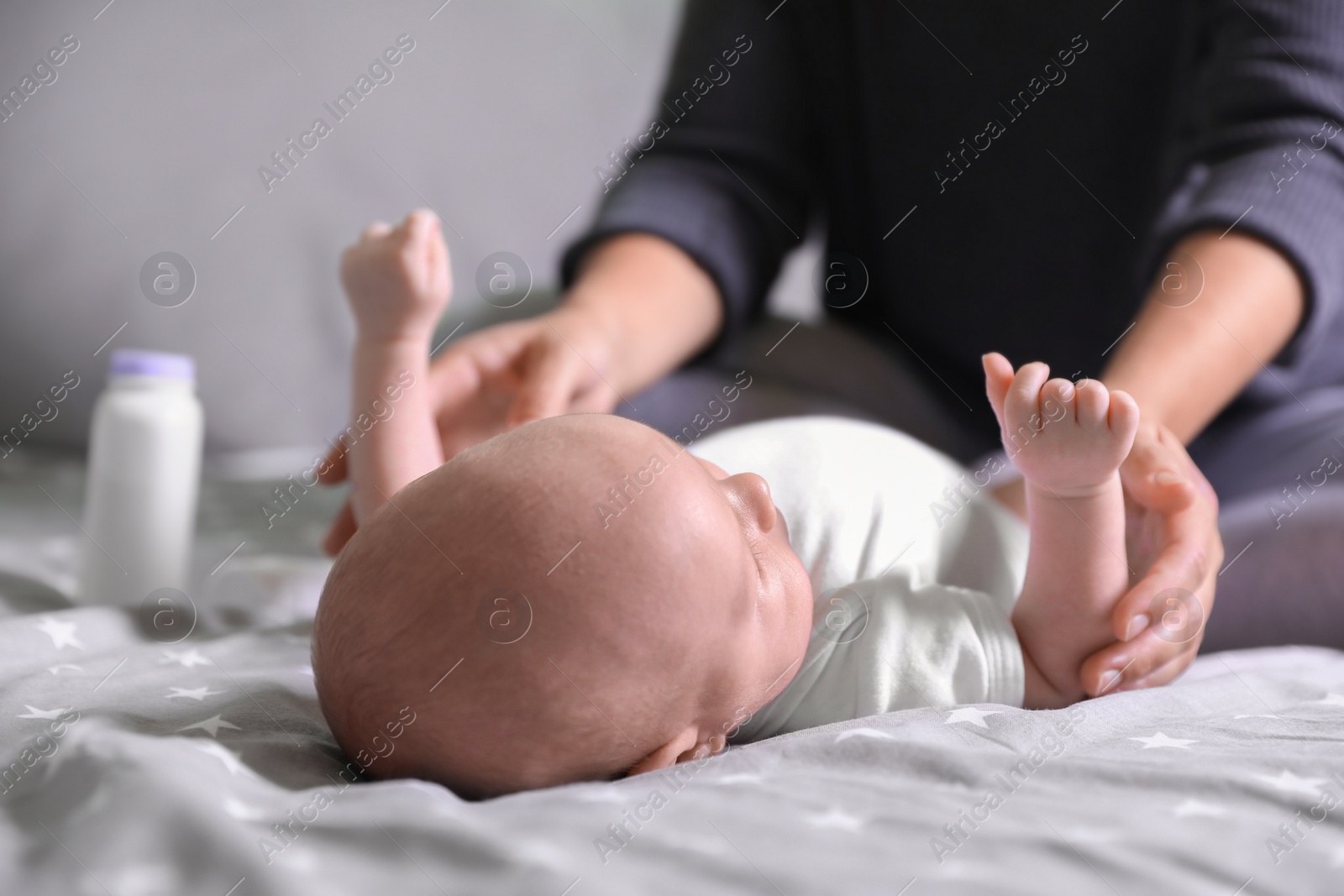 Photo of Mother and her little baby on bed, closeup