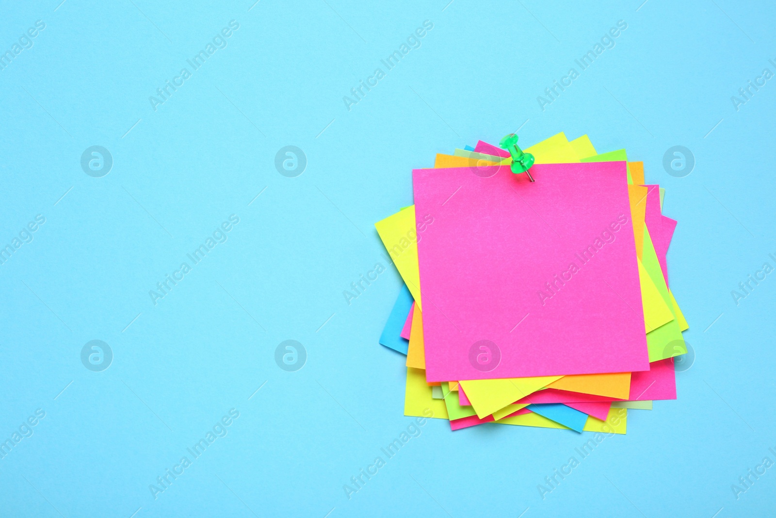 Photo of Many colorful notes on turquoise background. Space for text