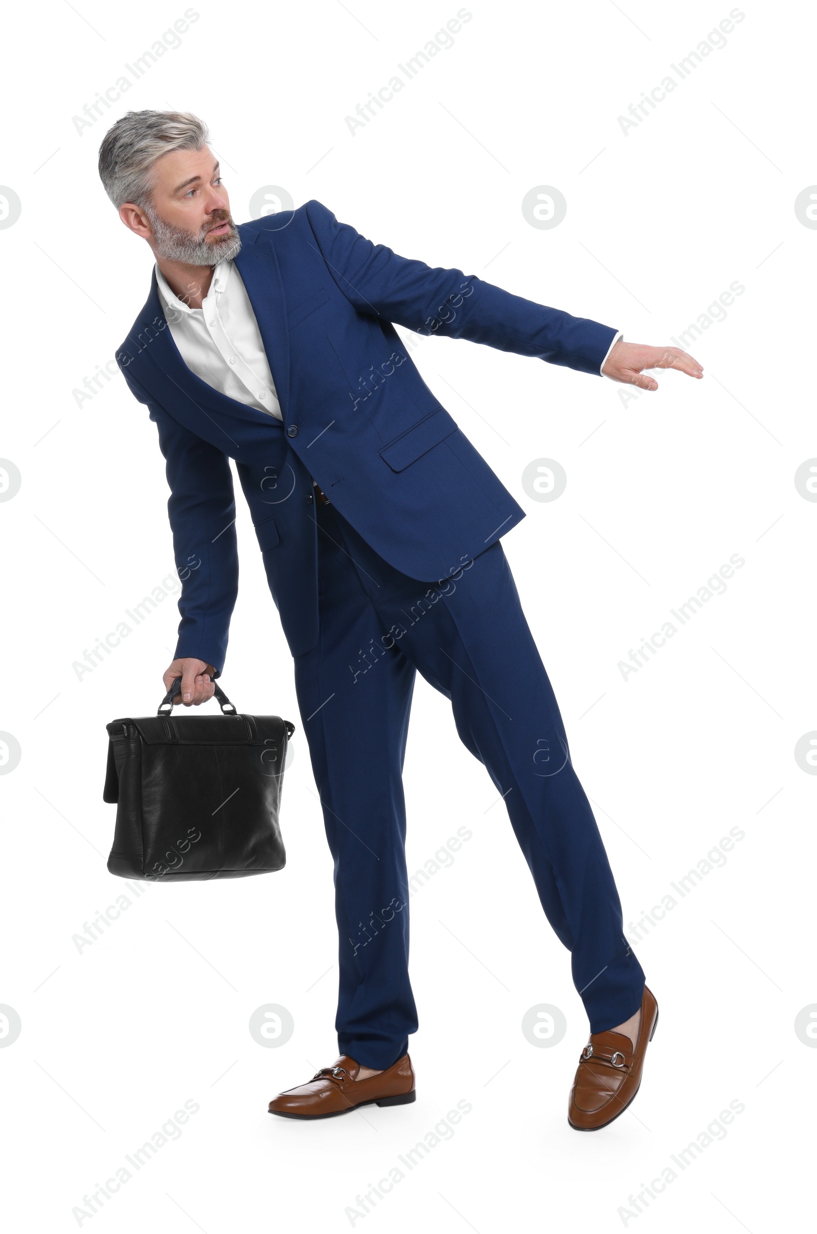 Photo of Mature businessman with briefcase posing on white background