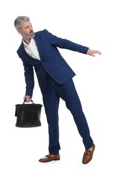 Photo of Mature businessman with briefcase posing on white background