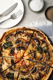 Photo of Delicious quiche with mushrooms served on grey table, flat lay