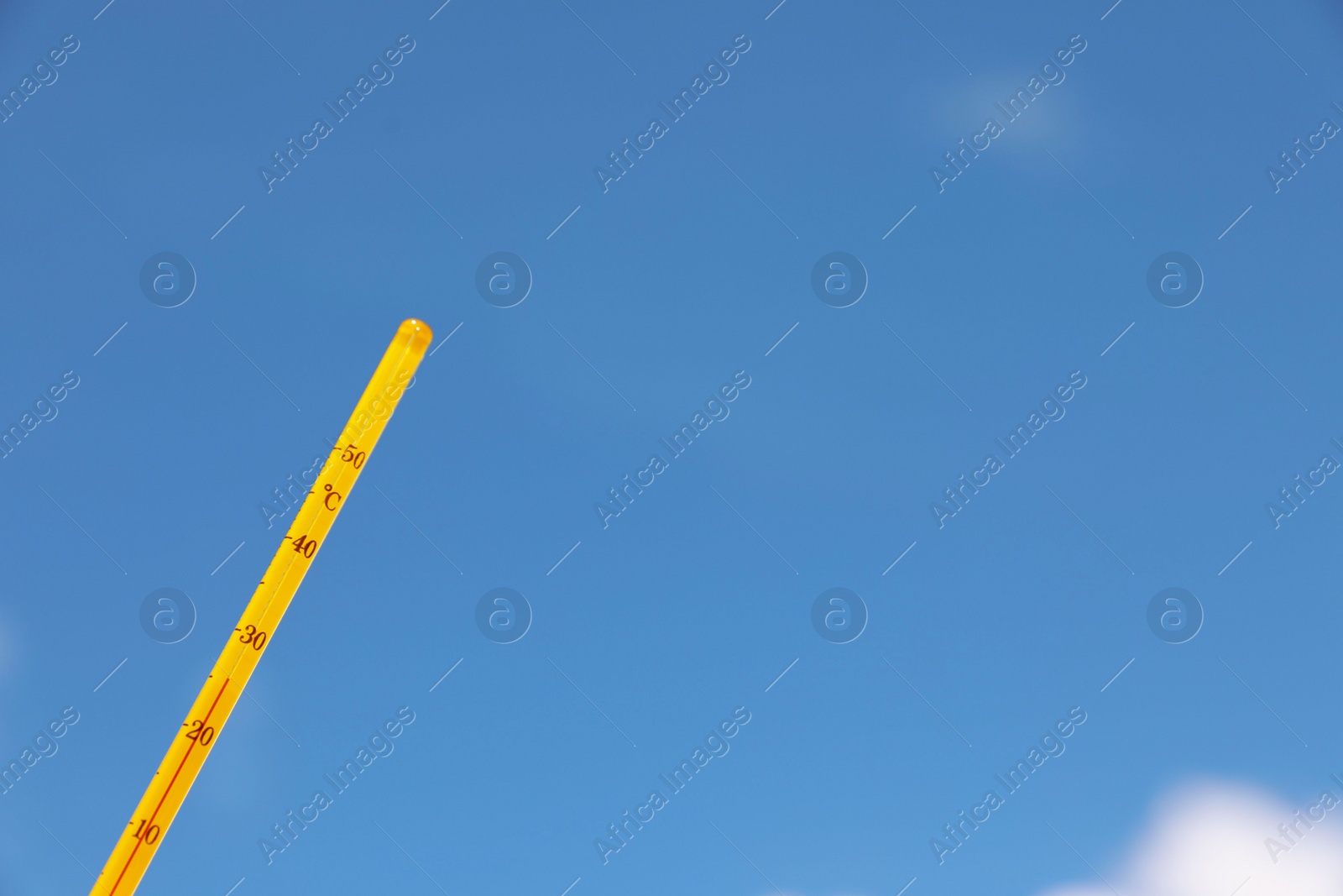 Photo of Weather thermometer against blue sky, space for text