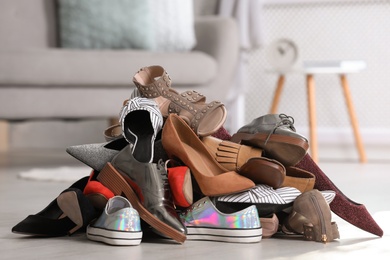 Photo of Pile of female shoes on floor indoors