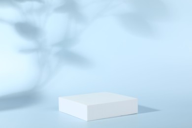 Presentation of product. White podium on light blue background. Space for text