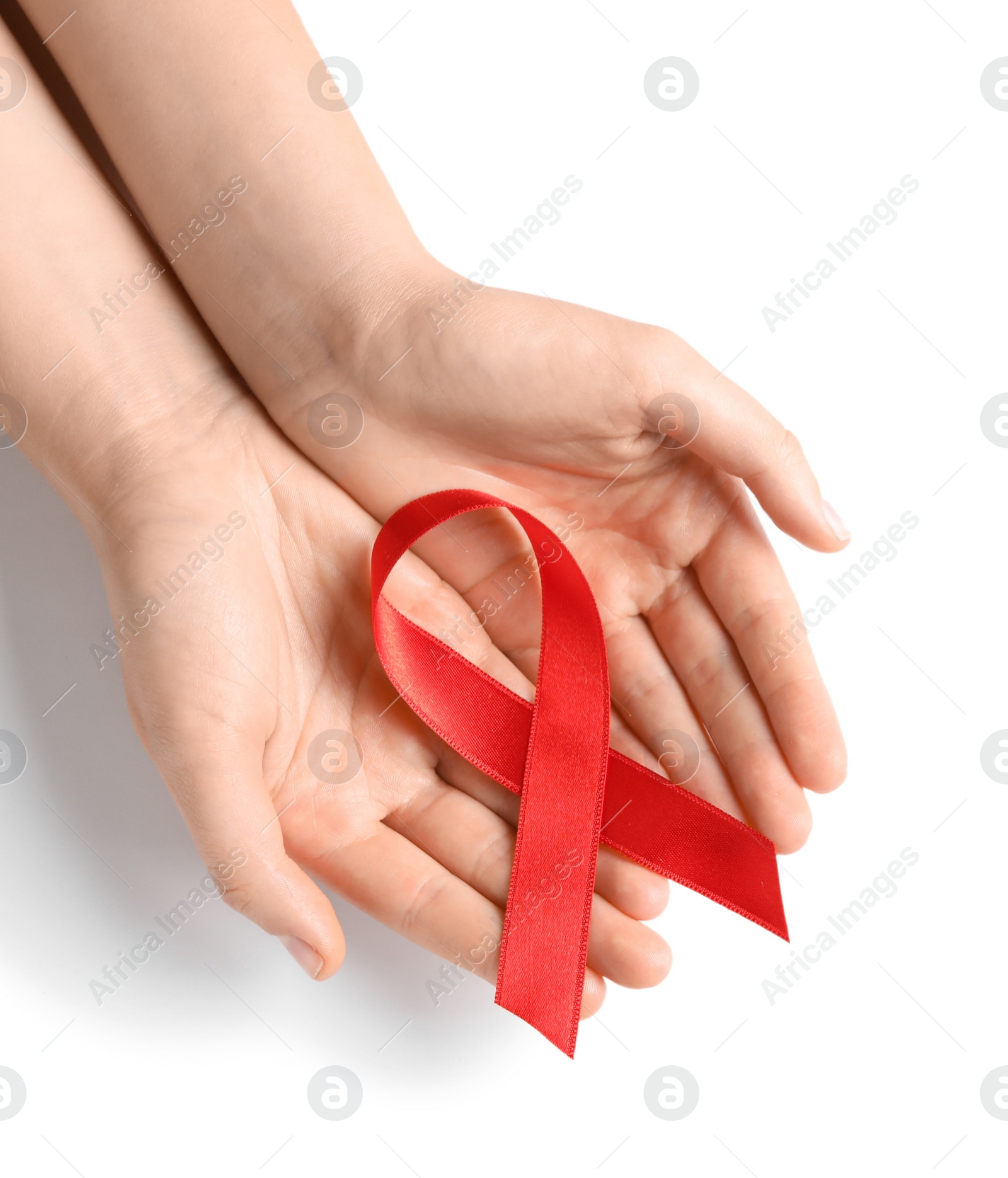 Photo of Woman holding red ribbon on white background, top view. Cancer awareness