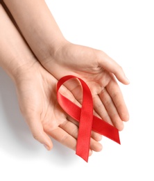 Photo of Woman holding red ribbon on white background, top view. Cancer awareness