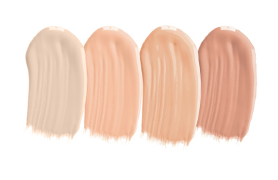 Image of Set of different foundation shades on white background, top view