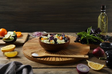Photo of Delicious salad with Chinese cabbage, tomato and basil served on wooden table