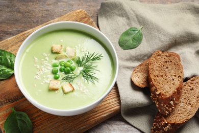 Photo of Fresh vegetable detox soup made of green peas served on table