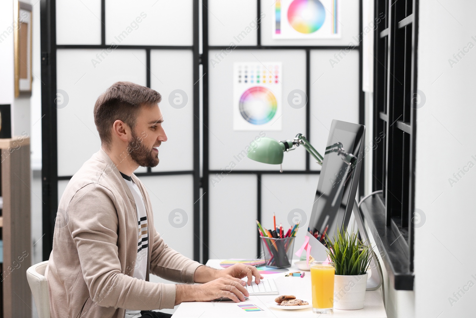 Photo of Male designer working at desk in office