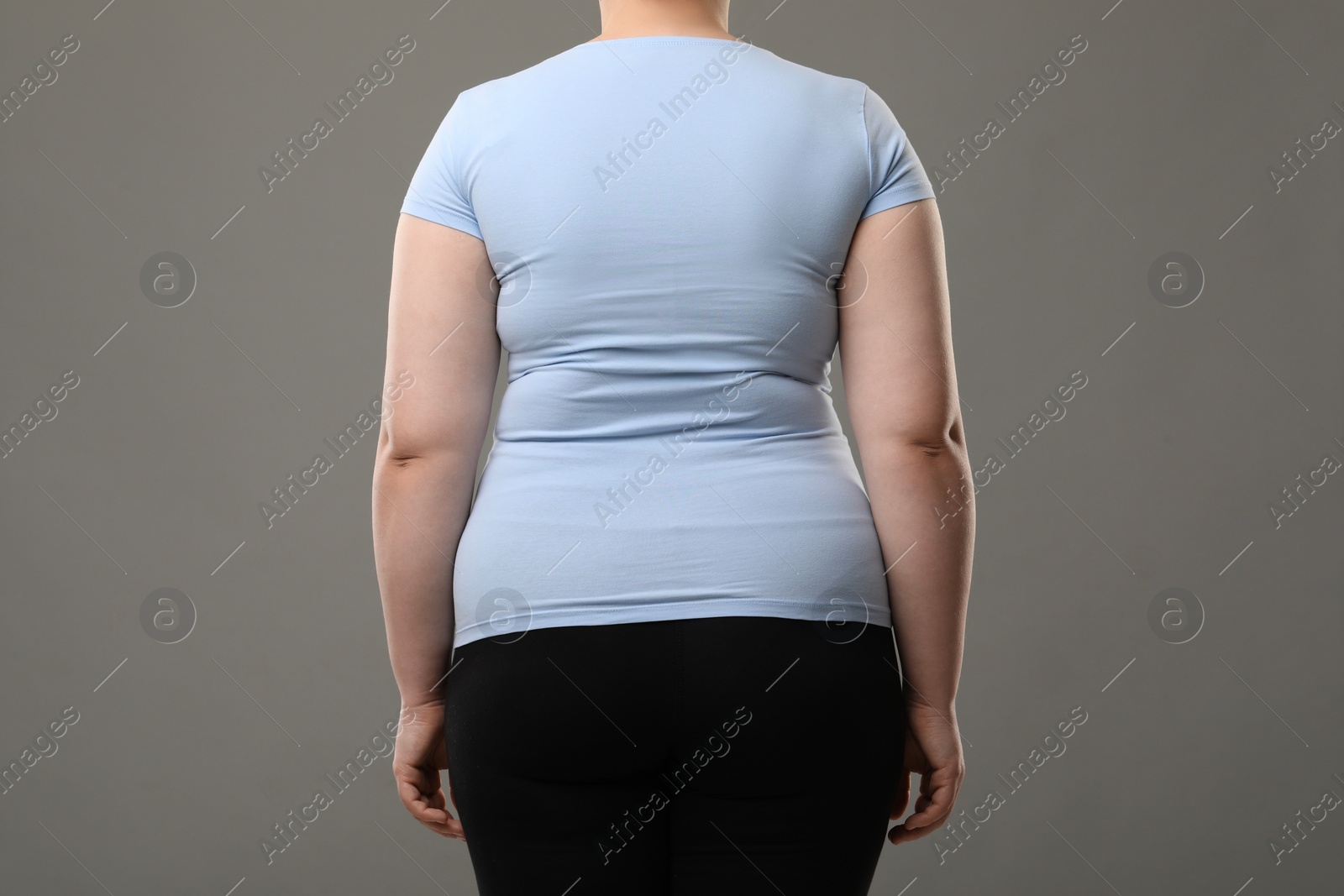 Photo of Overweight woman on grey background, back view