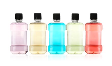 Photo of Bottles with mouthwash for teeth care on white background