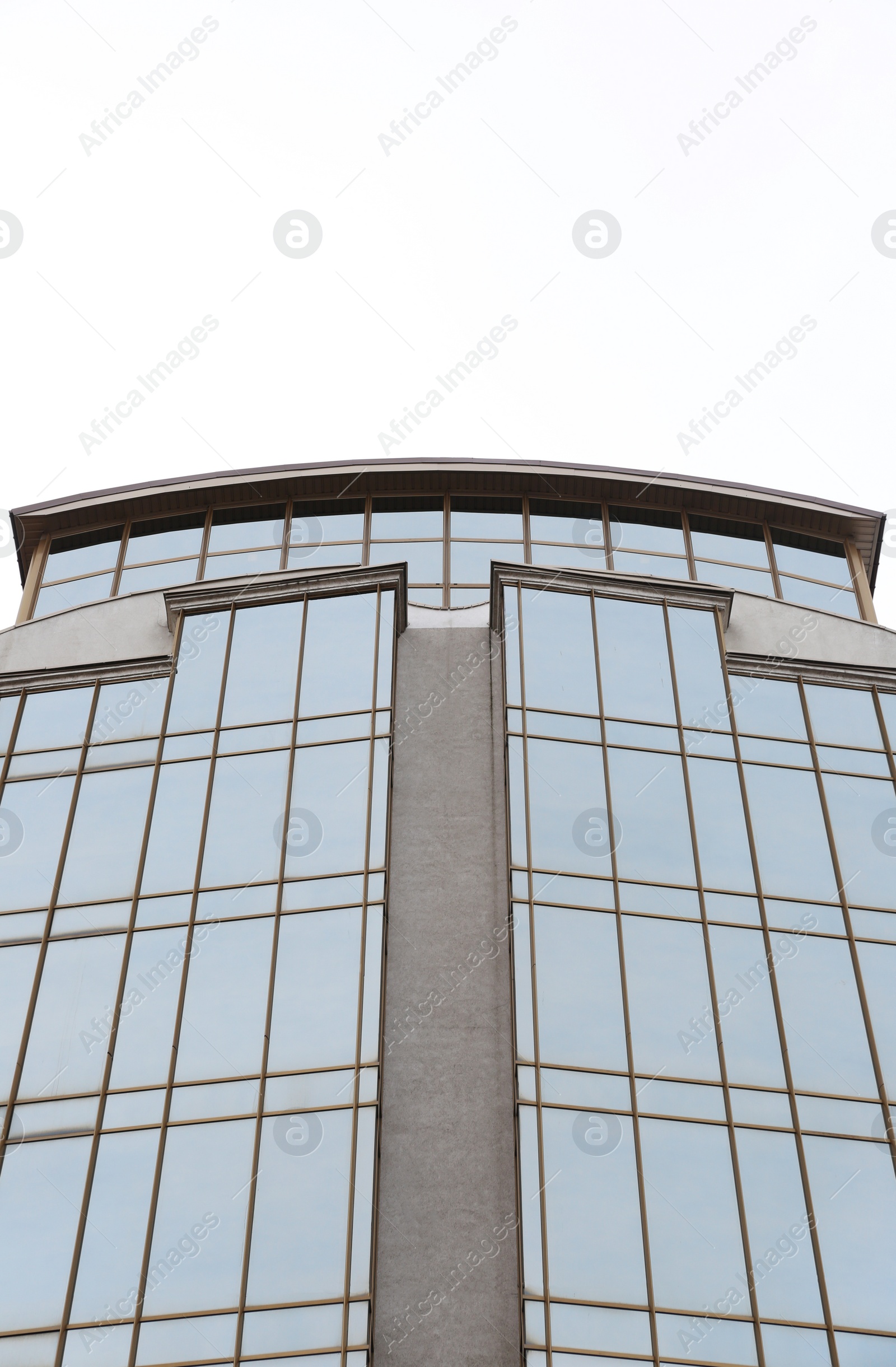 Photo of Modern office building with tinted windows against sky