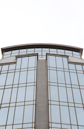 Modern office building with tinted windows against sky