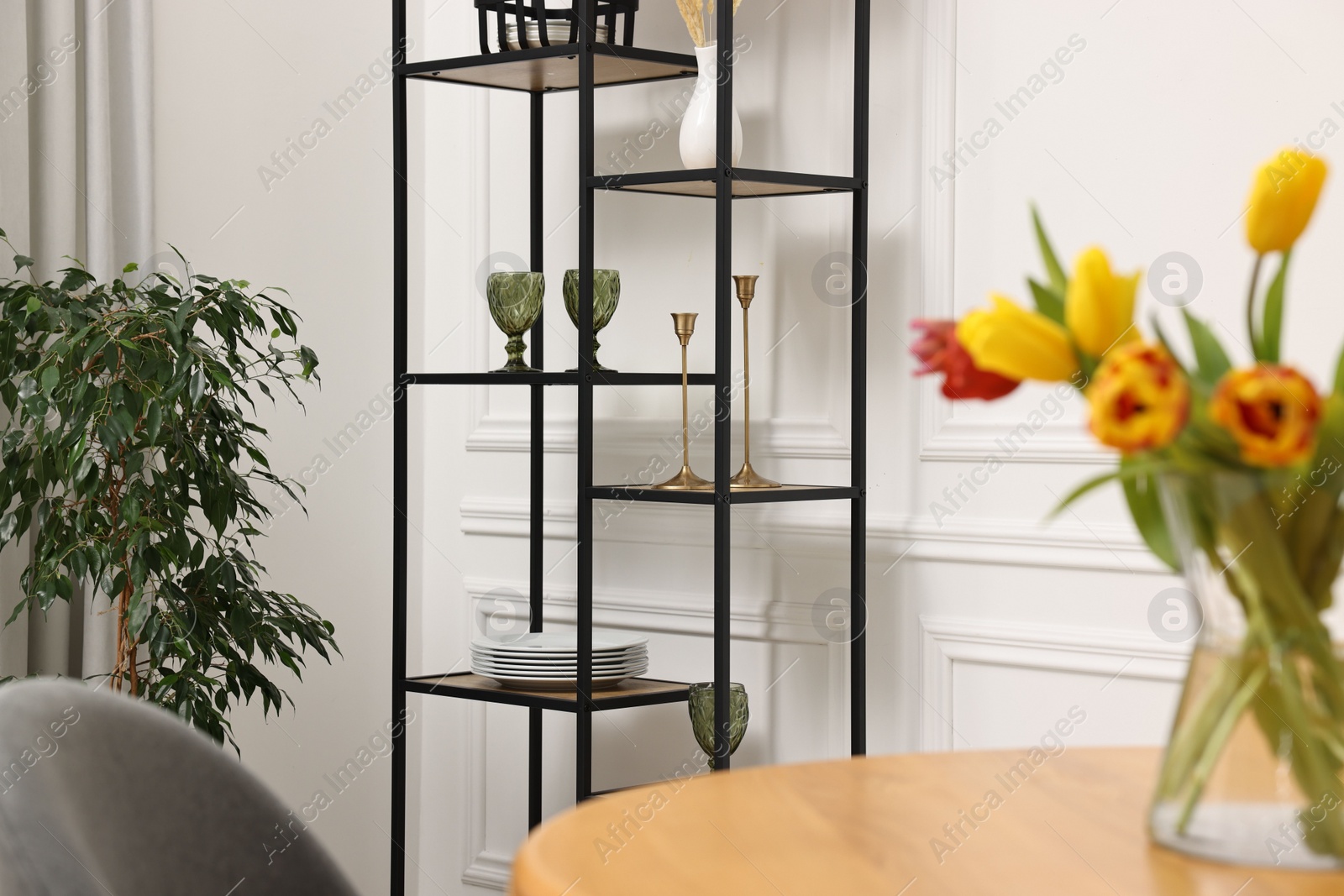 Photo of Vase with beautiful tulips on table in dining room