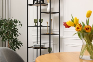 Photo of Vase with beautiful tulips on table in dining room