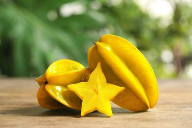 Delicious carambola fruits and slice on wooden table