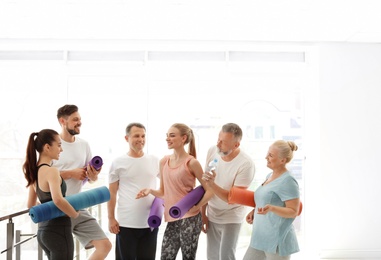 Photo of Group of people talking after yoga class indoors