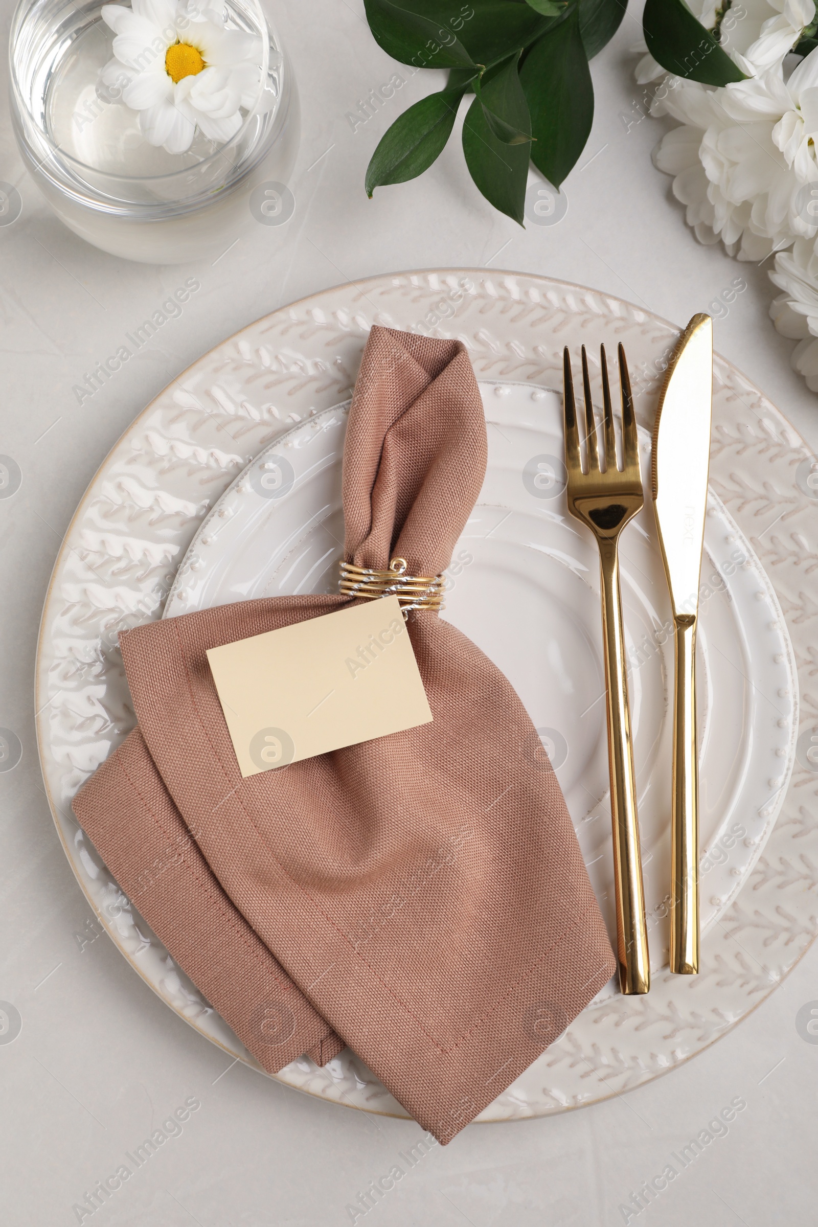 Photo of Elegant festive setting with floral decor on white table, flat lay