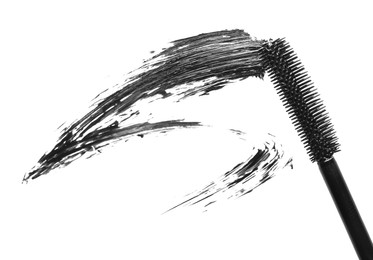 Photo of Smear of black mascara and applicator isolated on white, top view