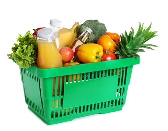 Photo of Shopping basket with grocery products on white background