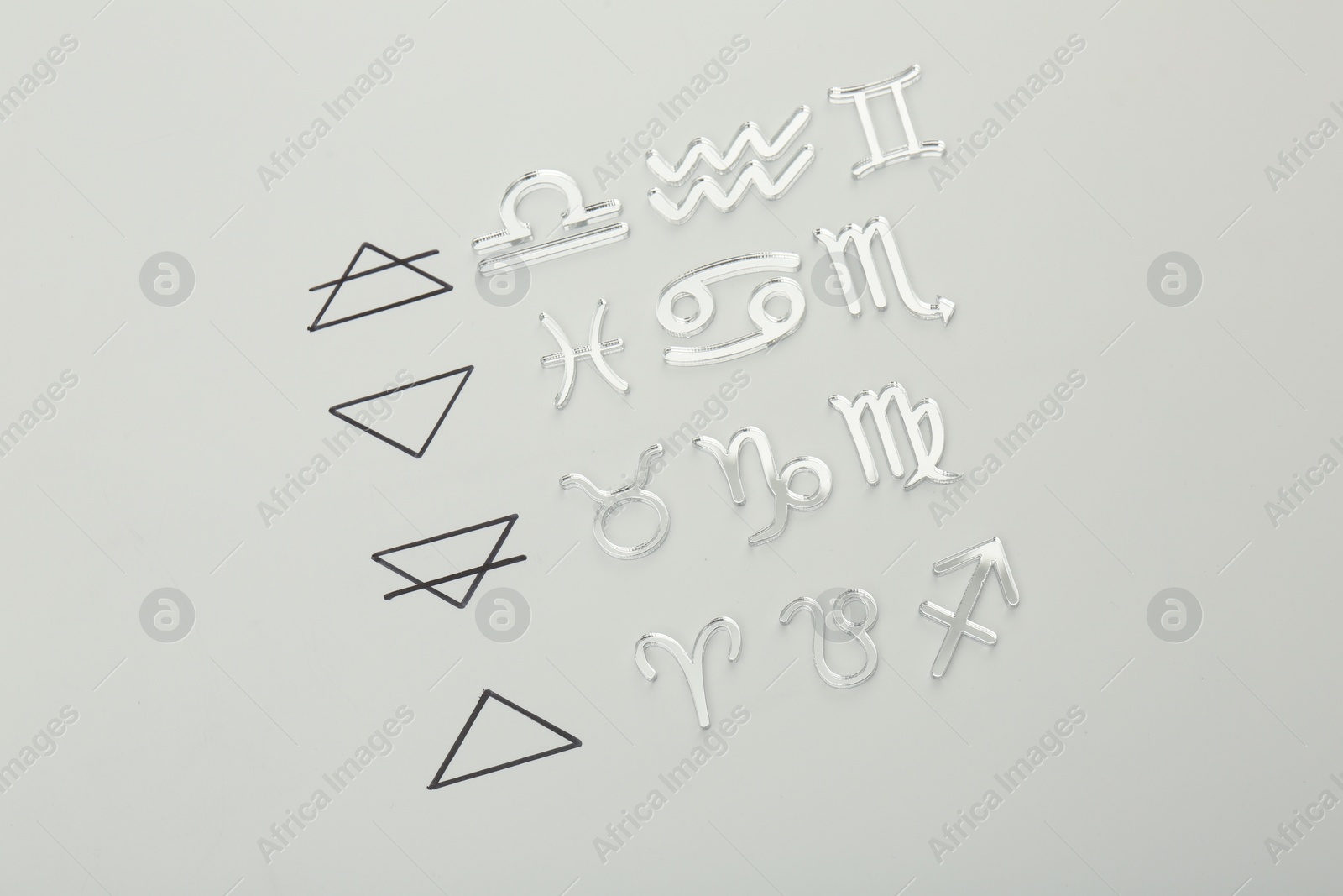 Photo of Zodiac triplicity. Four elements and corresponding signs on grey background, flat lay