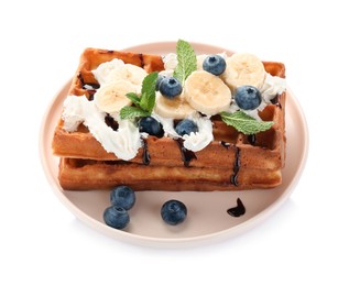 Photo of Plate of delicious Belgian waffles with blueberry, banana, whipped cream and chocolate sauce isolated on white