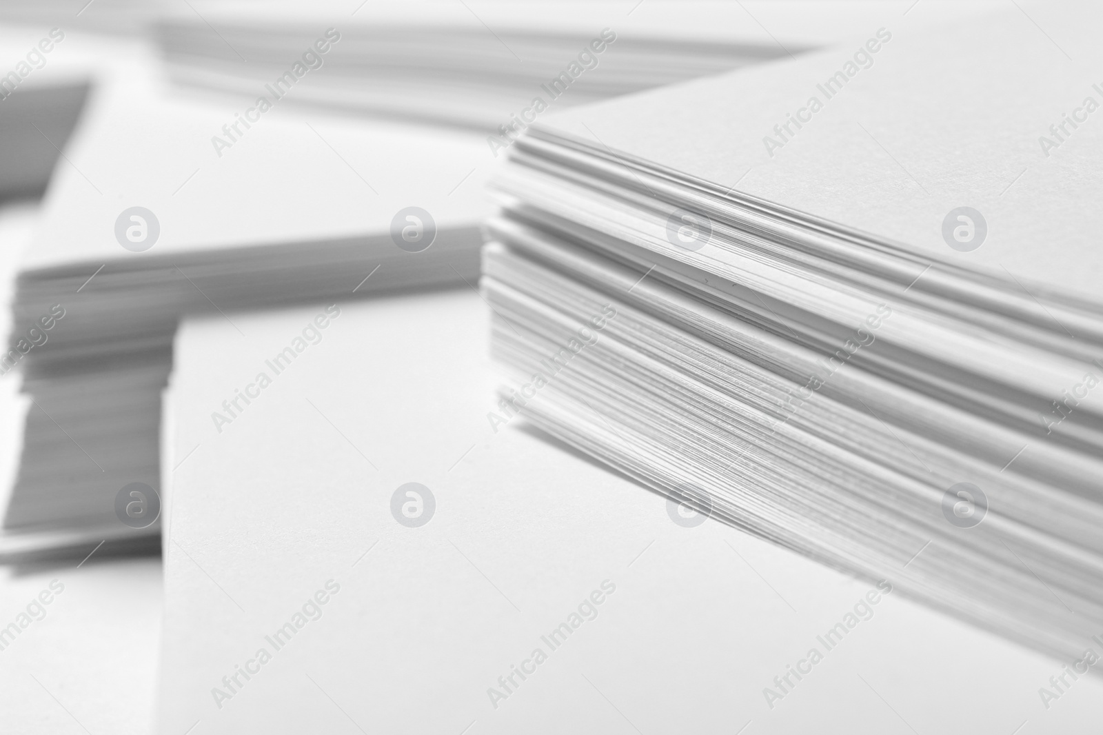 Photo of Stacks of paper sheets as background, closeup