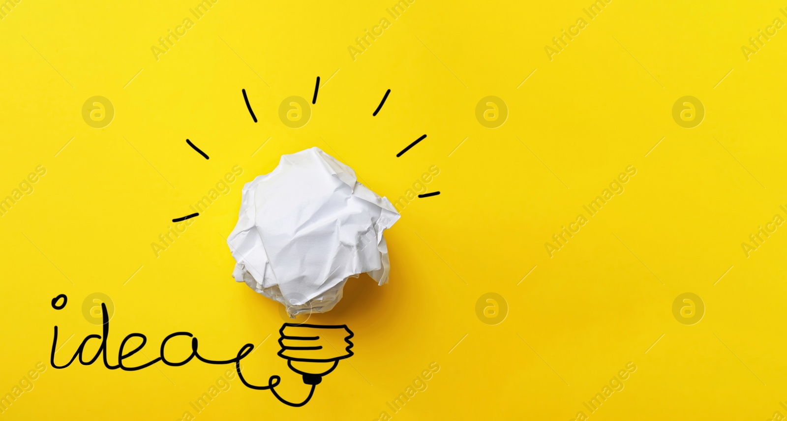 Image of Idea concept. Composition with crumpled paper ball and drawing of lamp bulb on yellow background, top view