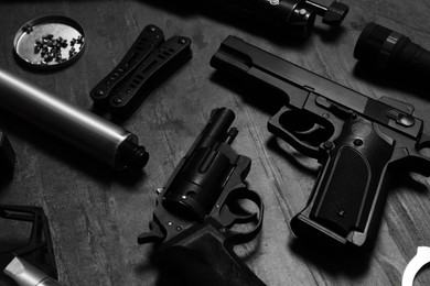 Photo of Different guns and ammunition on dark background