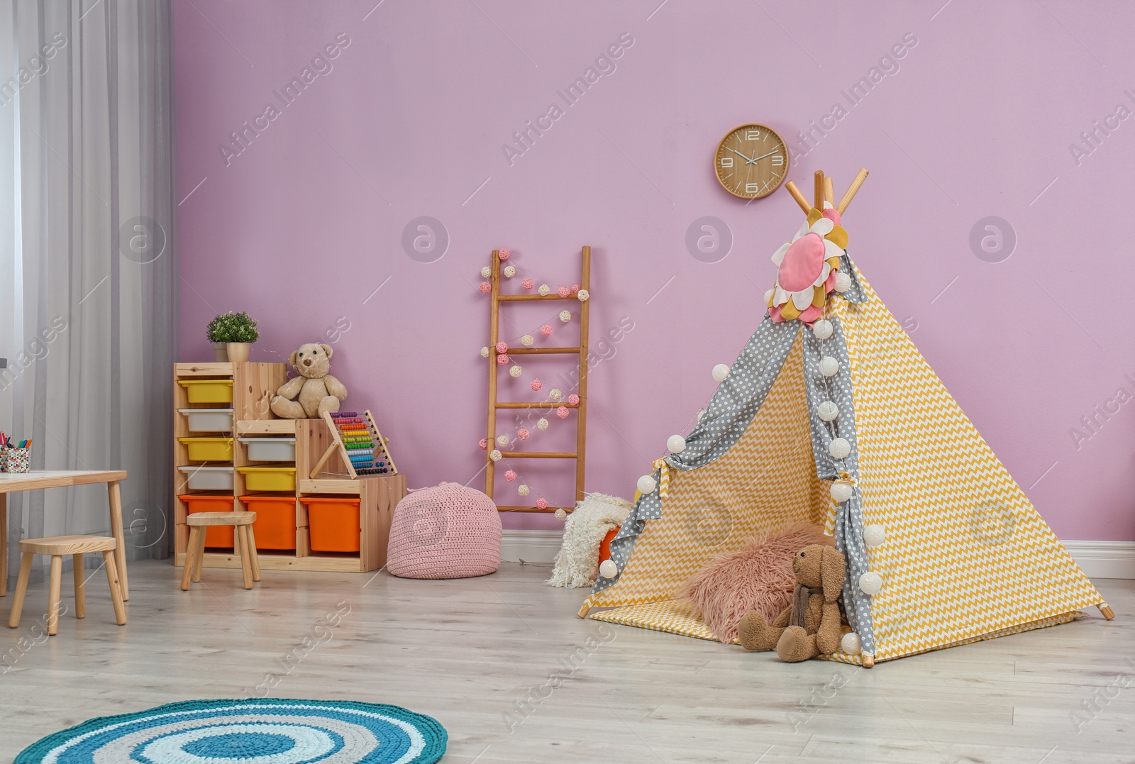 Photo of Modern nursery room interior with play tent for kids