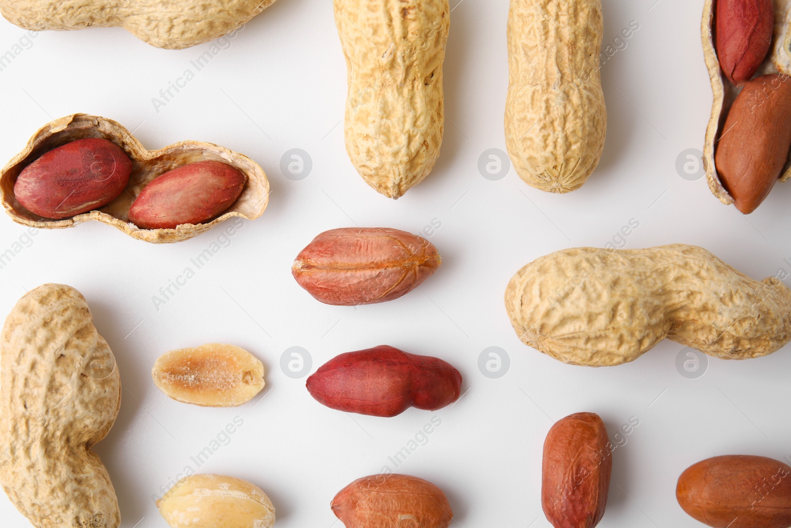 Photo of Fresh peanuts on white table, flat lay