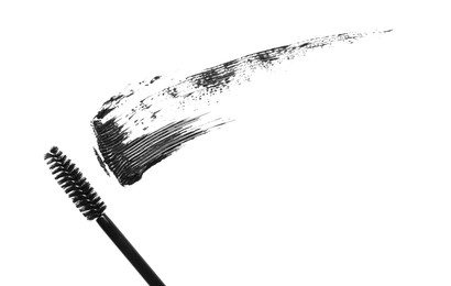 Photo of Smear of mascara and applicator isolated on white, top view