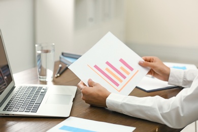 Business trainer working at table in office, closeup