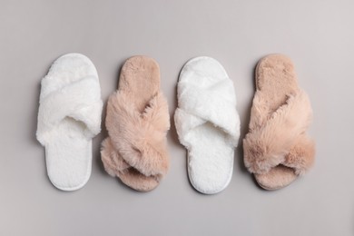 Photo of Different soft fluffy slippers on light grey background, flat lay