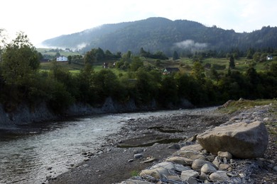 Photo of Picturesque view of beautiful river flowing near mountain