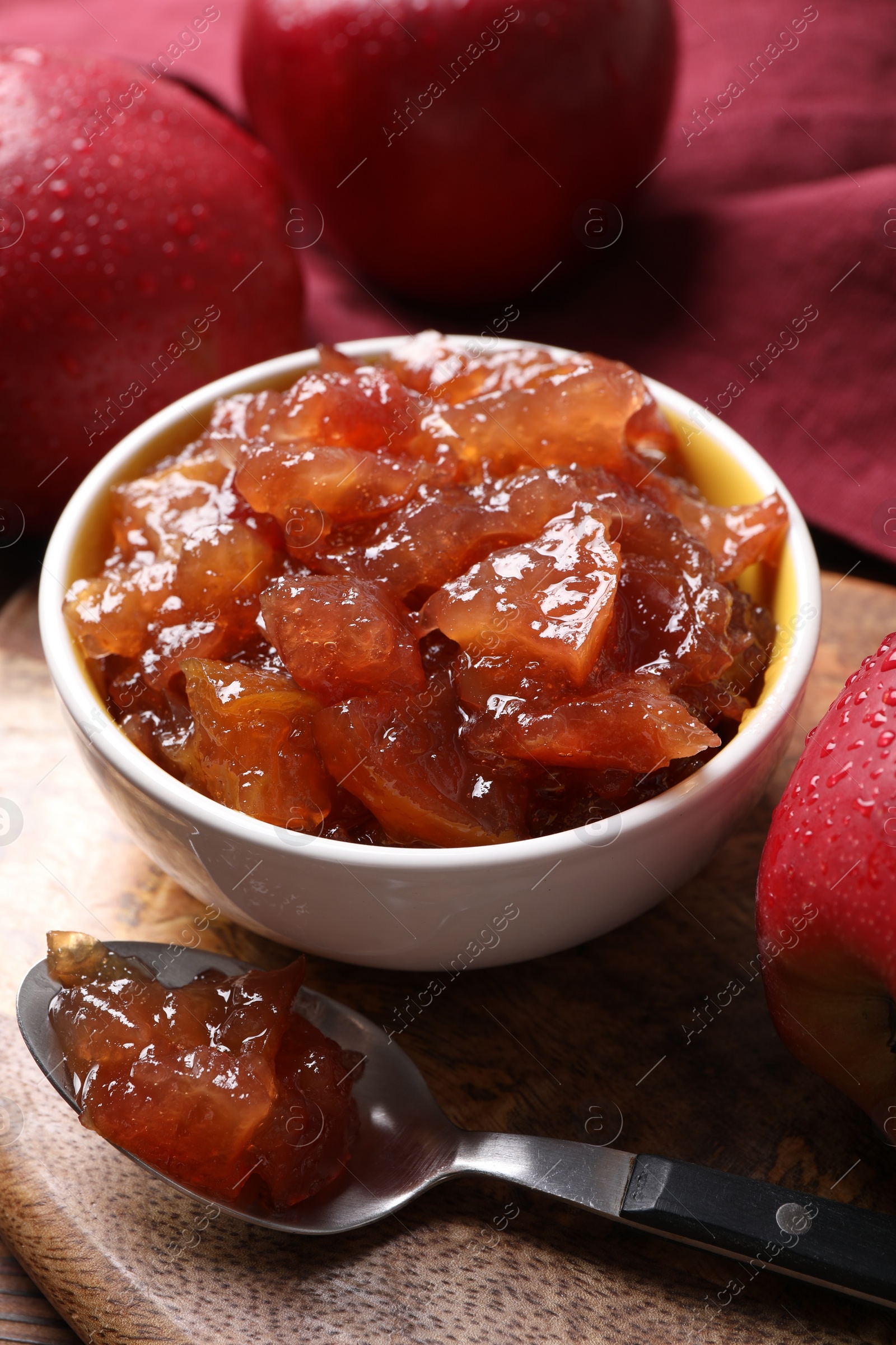 Photo of Delicious apple jam and fresh fruits on wooden table, closeup