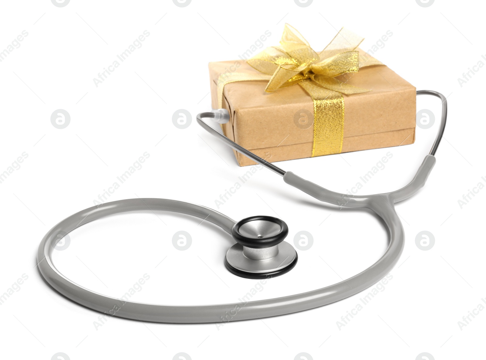 Photo of Stethoscope and gift box on white background. Happy Doctor's Day