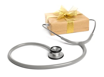 Photo of Stethoscope and gift box on white background. Happy Doctor's Day