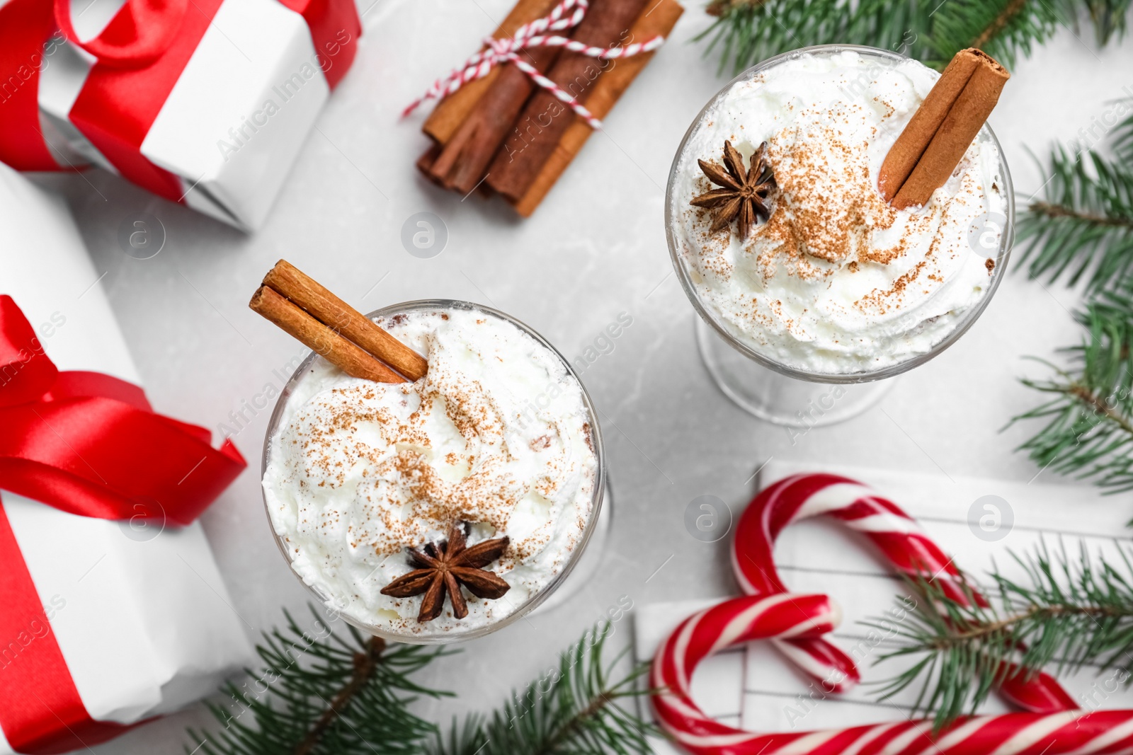 Photo of Delicious Christmas cocktail with liqueur on white table, flat lay