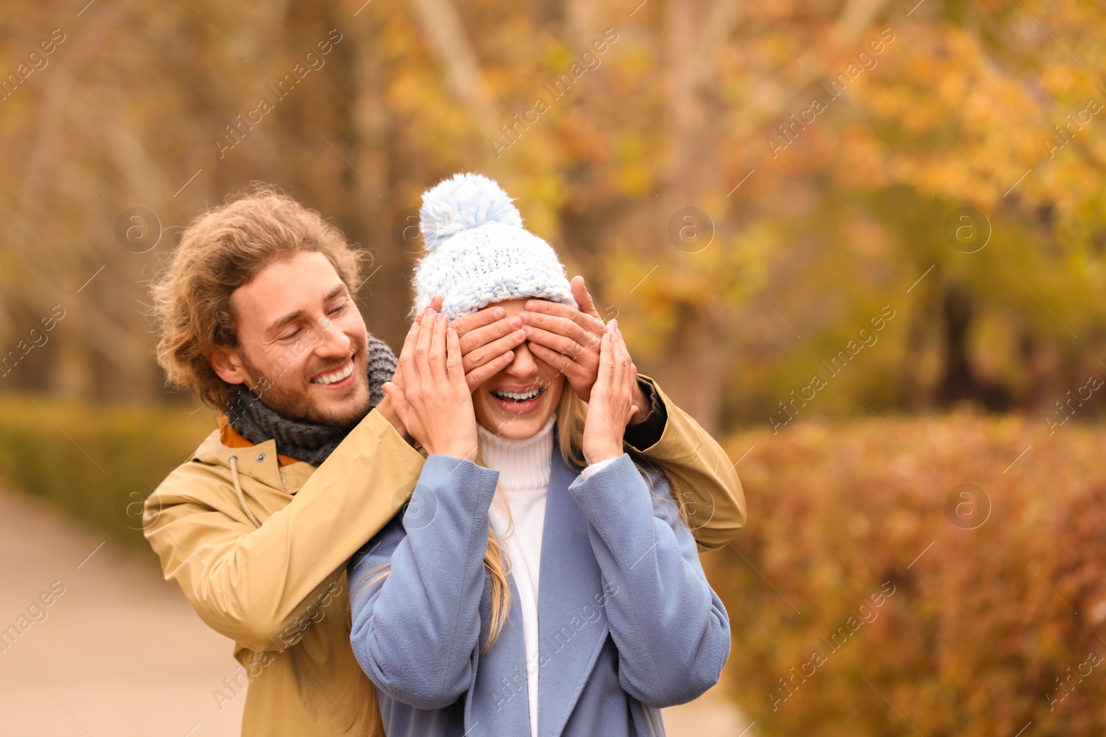 Photo of Young romantic couple having fun in park on autumn day