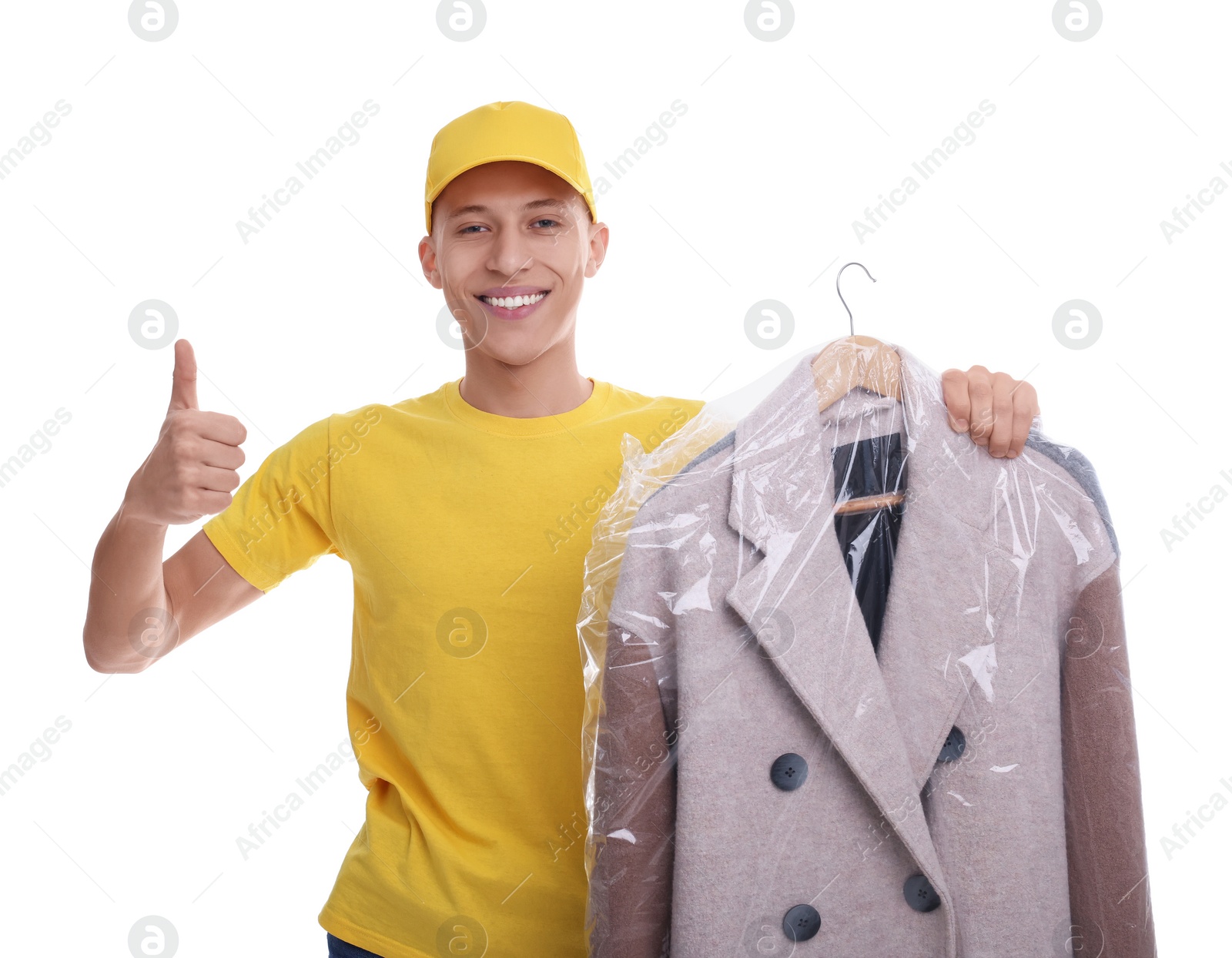 Photo of Dry-cleaning delivery. Happy courier holding coat in plastic bag and showing thumbs up on white background