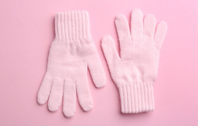 Pair of stylish woolen gloves on pink background, flat lay