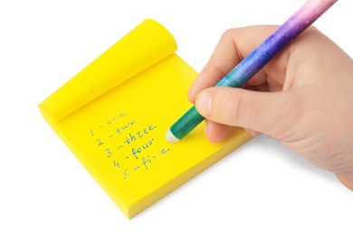 Photo of Child erasing word Five written with erasable pen on sticky note against white background, closeup