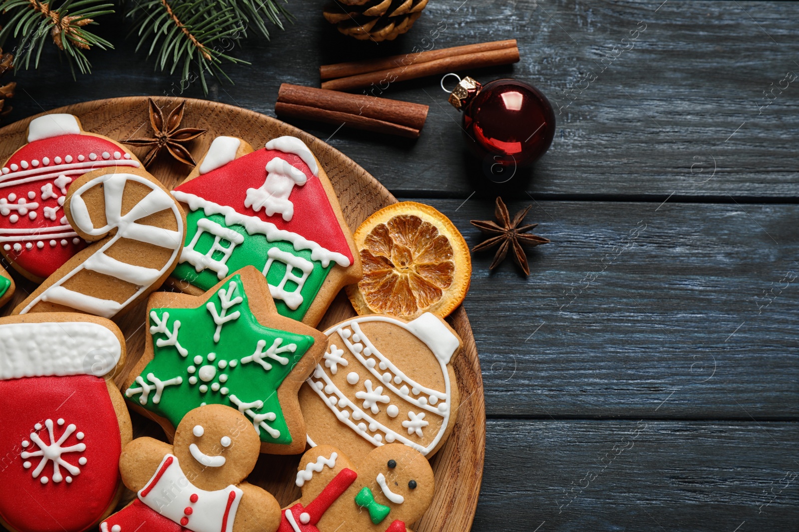 Photo of Tasty homemade Christmas cookies on dark blue wooden table, top view