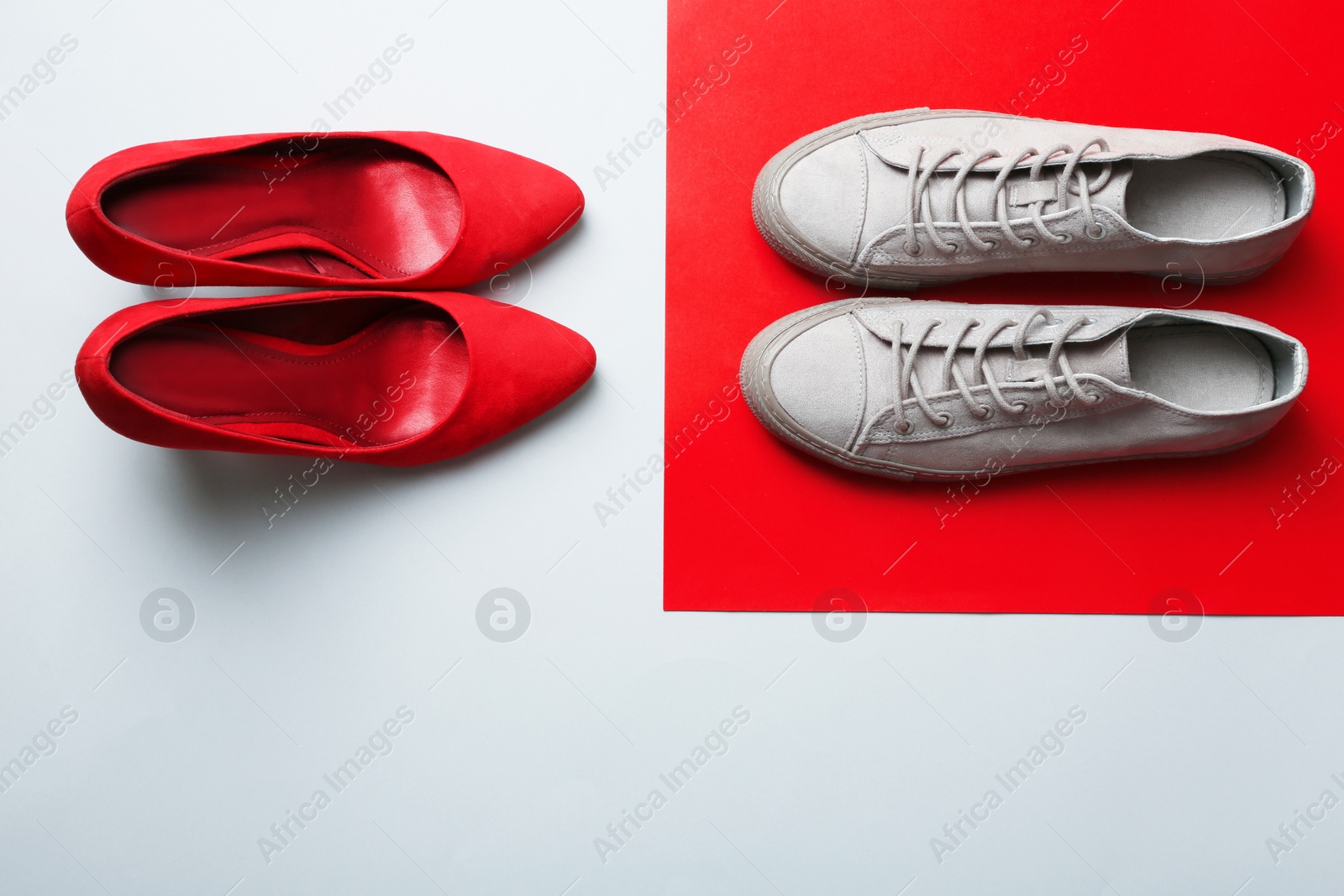 Photo of Different stylish shoes on color background, top view with space for text