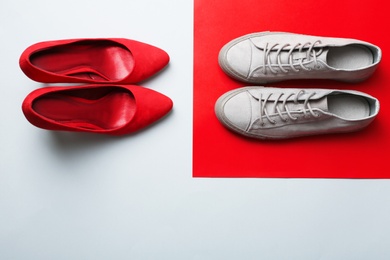 Different stylish shoes on color background, top view with space for text