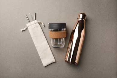 Photo of Different eco friendly products on grey background, flat lay. Conscious consumption