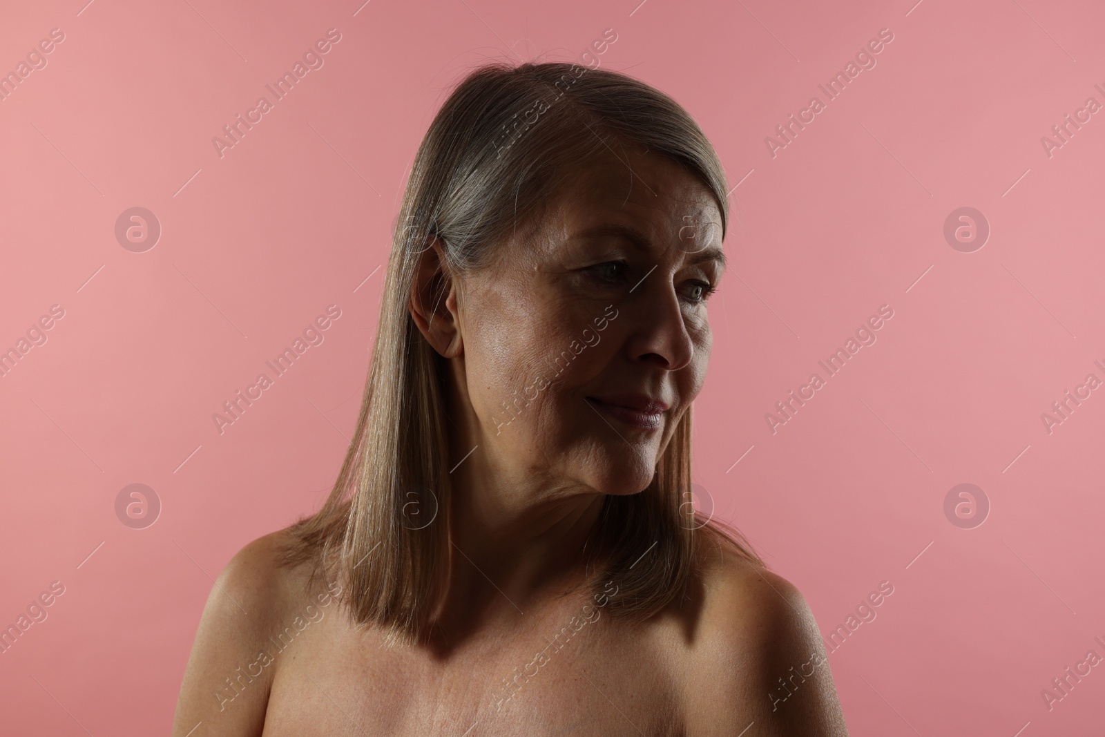 Photo of Beautiful woman with healthy skin on pink background