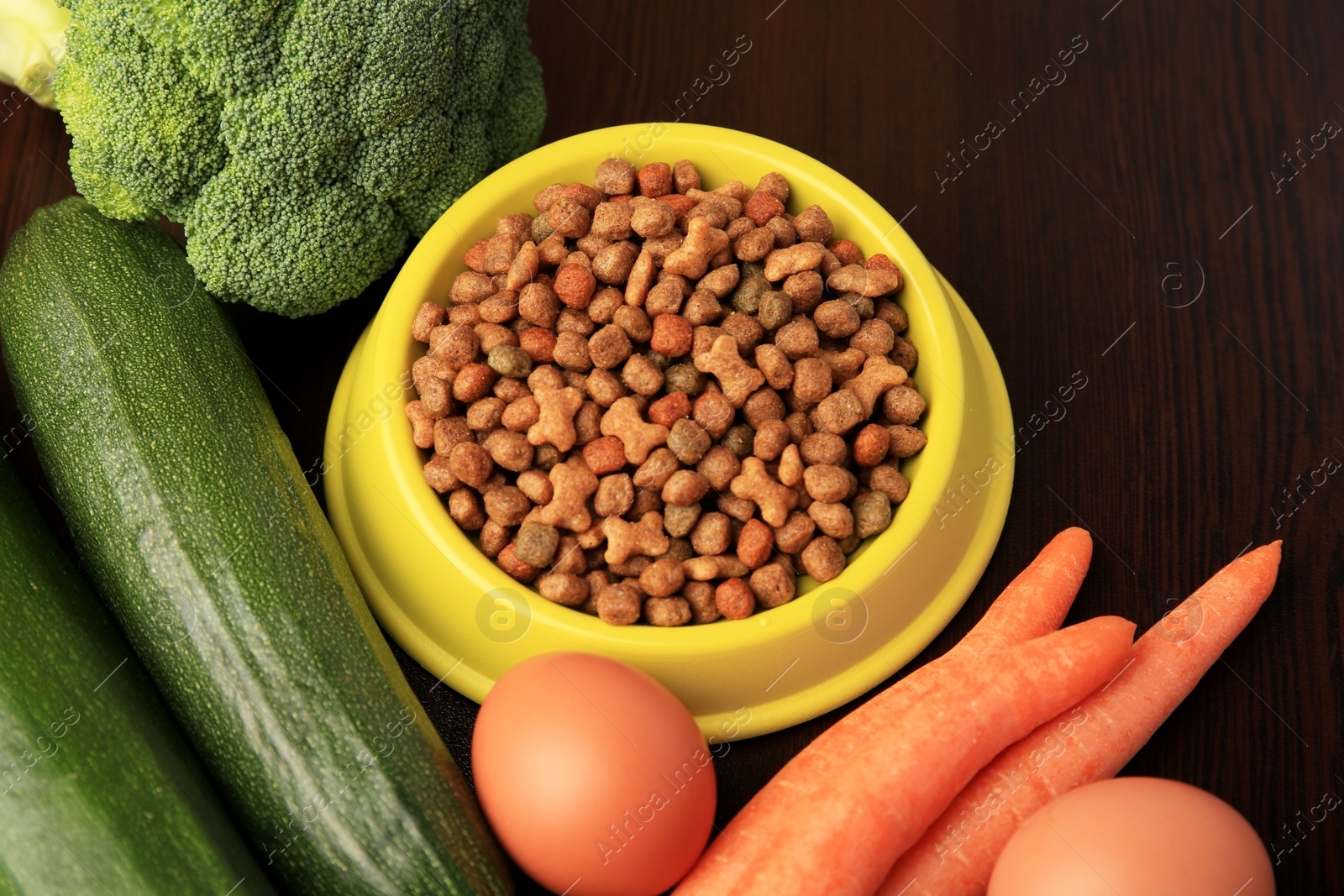 Photo of Dry pet food and products on wooden background